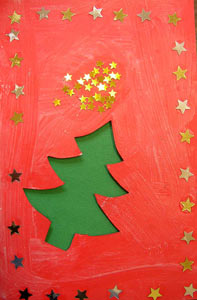 carte de Noël avec un sapin découpé et des étoiles